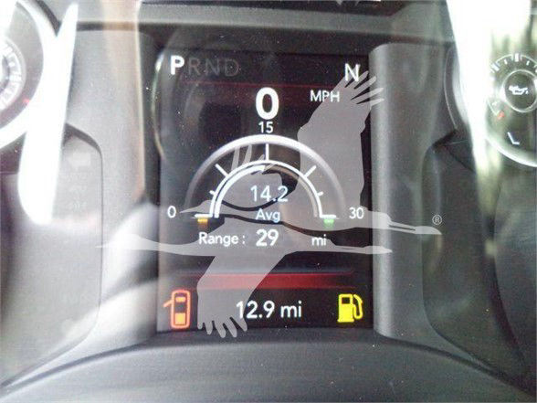 Dashboard display showing 0 mph, gear indicators P R N D, 0 mph, average 14.2, range 29 mi, fuel gauge low, 12.9 mi range remaining, odometer style display.