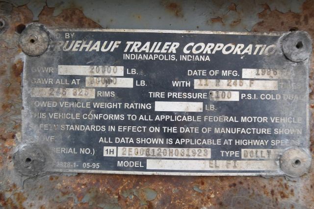 Fruehauf trailer data plate showing GVWR 20000 lb, GAWR, tire pressure 100 P.S.I., model ELFI, serial numbers, and manufacturing date.