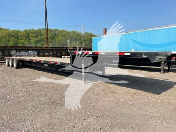 2016 Transcraft steel drop trailer with multi-axle configuration, side rails, and reflective tape. VIN 1TTE533S2G3896479, stock 53-5854, drop deck trailer, used.