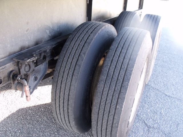 Trailer axle and dual tires visible on Fontaine flatbed expandable trailer carrier.