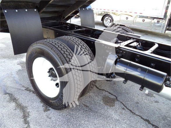 Freightliner Business Class M2 106 rear axle with dual wheels and exhaust. Visible chassis frame and tire.