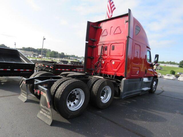 Front and side view of a red 2016 Freightliner Cascadia Evolution tractor without a trailer, showing rear triple-axle configuration and exposed fifth wheel area.