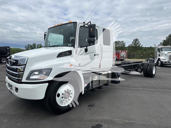 2026 Hino L6 cab and chassis truck in white, side view with front grille and cab mirrors visible.