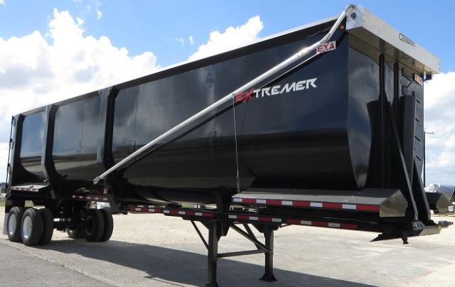 EXA ExtremER scrap/demolition frameless trailer with black steel body and white top rail.