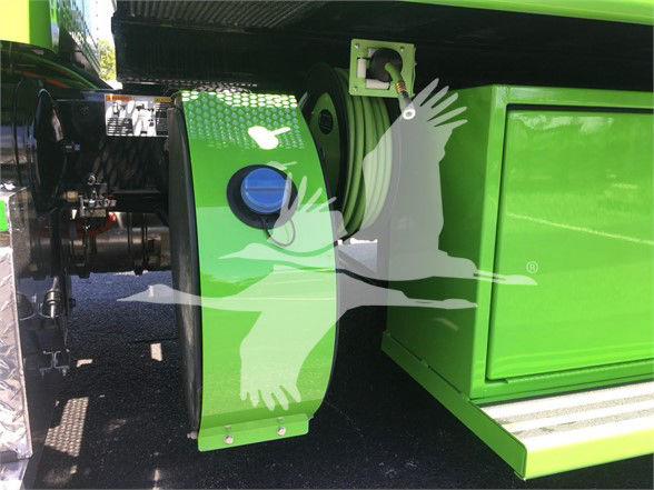 Green Peterbilt 337 fuel or storage compartment with black components visible, wheel area, and side step; stock number J52310 in listing.