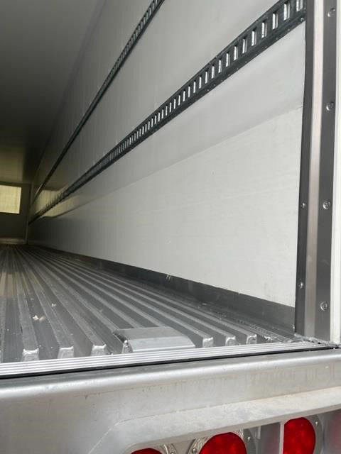 Trailer interior of a 2024 CIMC Cool Globe Reefer Van showing cargo area with ribbed floor and sidewall rails.