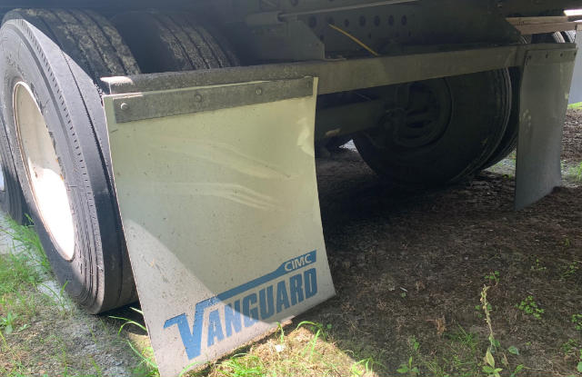Vanguard trailer mud flaps with Vanguard logo and wheel area visible under trailer.