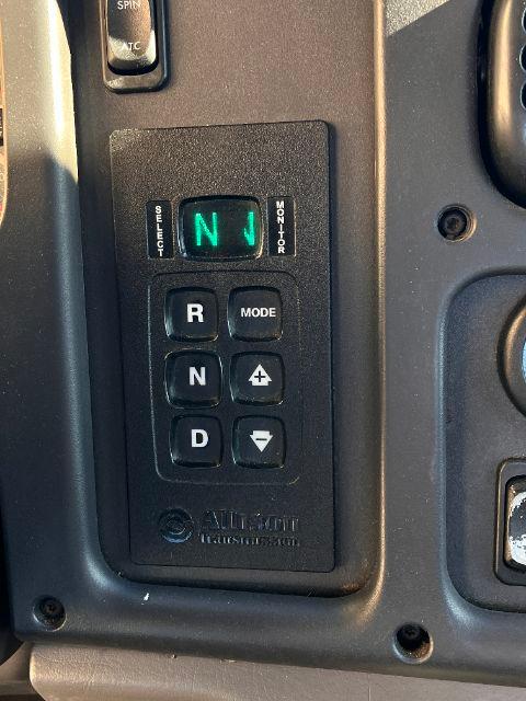 Cab and chassis gear selector panel showing N gear illuminated in green, R, N, D, plus MODE and +/- controls, with small buttons around.