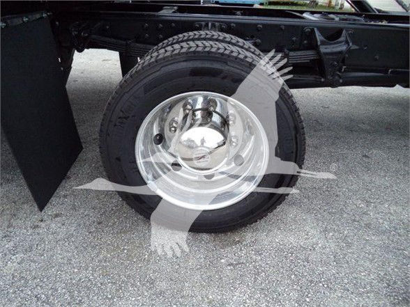 Wheel on truck with chrome hubcap and tire, frame visible; no legible labels or serials evident.