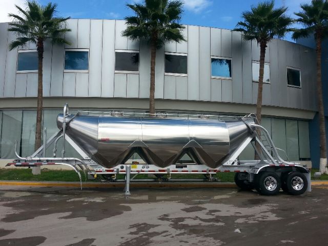Aluminum 1040 pneumatic trailer by Gallegos in new condition, side view with three hopper-like sections and tandem axles.