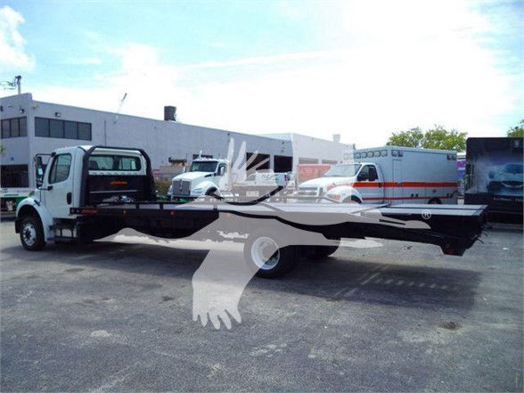 Flatbed truck in a dealership lot with a long chassis and white cab, Freightliner Business Class M2 106.