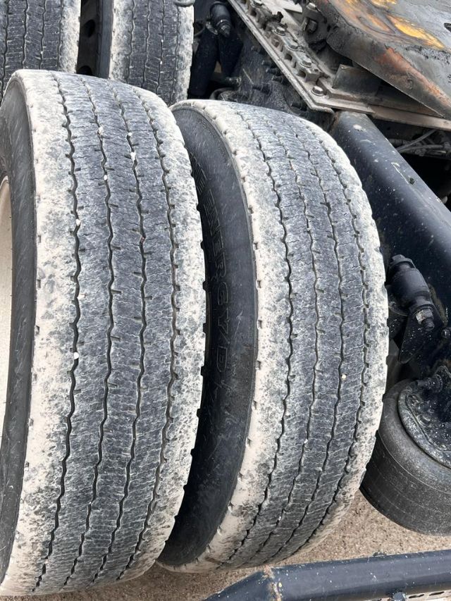 Freightliner Cascadia trailer axles with dual rear tires and visible wear on tread.