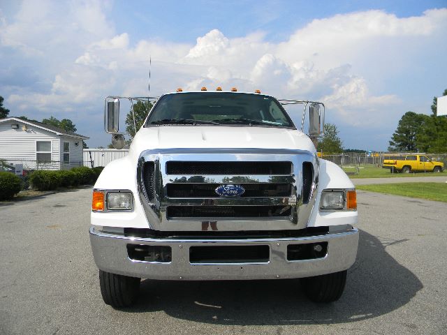 Front view of a white 2011 Ford F-750 Super Duty Crew Cab truck with chrome grille and bumper.