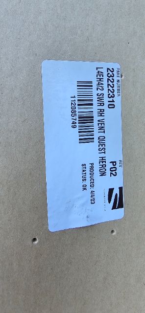 Label sticker with barcode and text attached to a wooden surface.