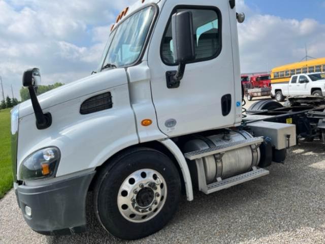 Freightliner Cascadia 2015 cab showing front left side with fuel tanks and wheel.