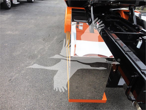 Peterbilt 337 tow truck chassis with orange paint and chrome panel; stock number J06176 visible in listing context.