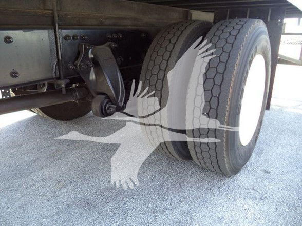 Dual rear wheels and suspension under a 2016 Business Class M2 106 truck with dual tires.