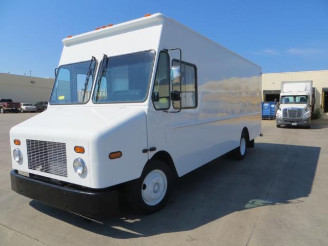 Box truck body with flat front cab and large windshield, white Freightliner MT45 in-service stock photo.