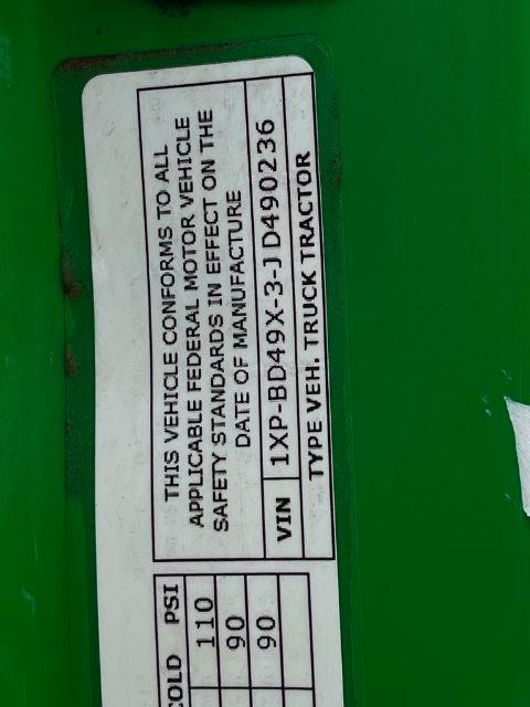 Vehicle VIN and type label on a green Peterbilt truck showing VIN and 'TYPE VEH: TRUCK-TRACTOR' text along the label.