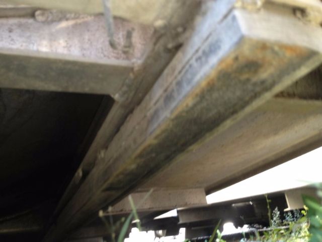 Underside of a Progress VA72 vacuum tank truck showing metal framework and support beams.