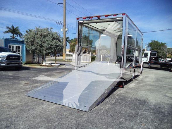 Kenworth T280 new tow truck with metallic ramp and enclosed cabin.