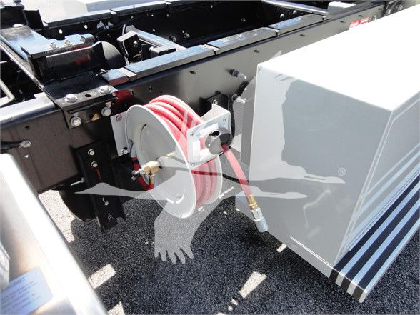 Hino 268A truck chassis with a red hose reel and reel hose connected near the cab area.