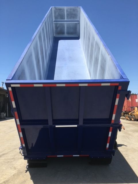 Blue 40 ft square dump trailer open top view showing interior and rear doors. No visible text on trailer.