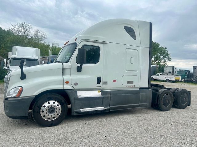 2019 Freightliner Cascadia 125 sleeper cab tractor side view showing front wheel, fuel tanks, and rear tandem axle.