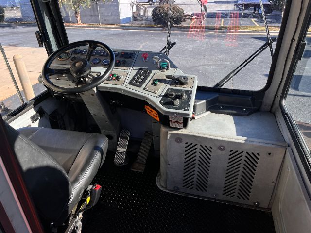 Operator cabin of a 2013 TICO PROS POTTER? DOT yard truck with steering wheel, dashboard, pedals, and control panel.