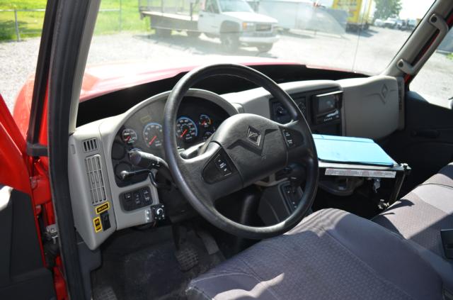 Interior of a 2013 International TerraStar truck showing steering wheel, dashboard, and driver's seat.