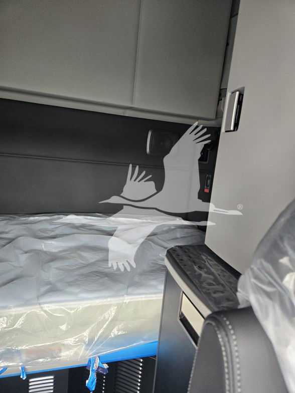 Kenworth T680 truck interior showing sleeper cab with panel, door pocket, and bunk area.