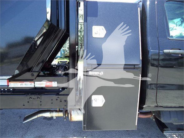 Truck side view showing a toolbox mounted behind the cab on a 2023 International CV refuse truck.