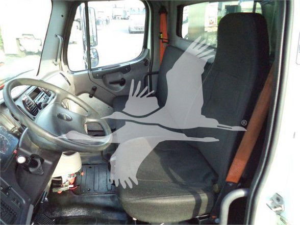 Cab interior of a 2012 Freightliner Business Class M2 106 showing driver seat, steering wheel, and bench passenger seat.