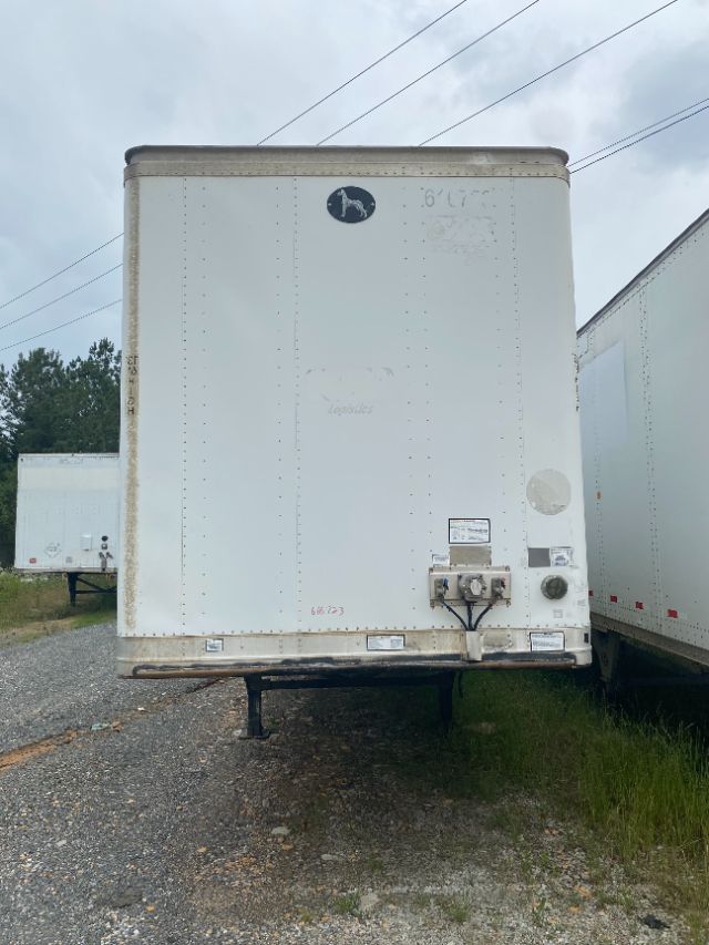 Trailer rear door of a 2015 Wabash Duraplate trailer showing hitch and utility connections and a circular logo near top center.