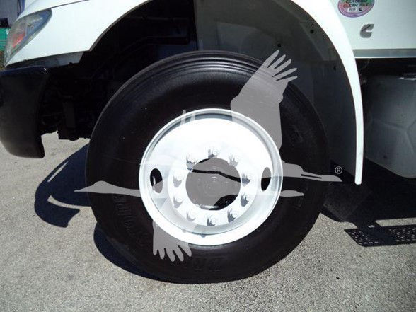 Truck front left wheel and fender with partial door text and stickers. Visible text includes VIN and stock details in listing context, not on the image itself.