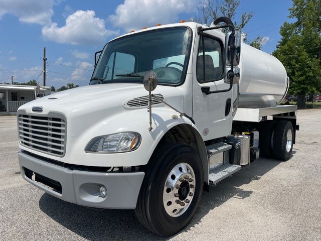 Front-left view of a white 2013 Freightliner M2 sewer rodder septictank truck showing front grille, cab, side mirror, and mounted tank; appears in-service with clean exterior.