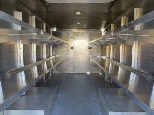 Freightliner MT45 step van interior with metal shelving on both sides and a closed rear door.