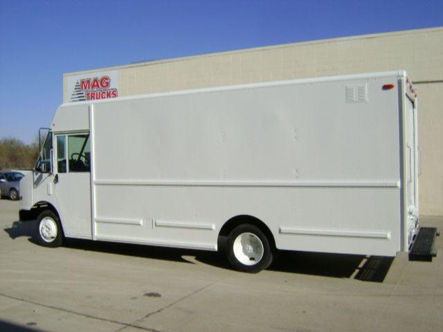 Box truck exterior side view showing a white Freightliner MT45 step van with MAG Trucks logo in background.