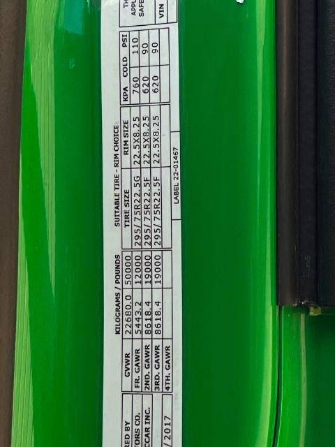 Vehicle data plate on green Peterbilt showing GVWR, GAWR, tire sizes, and weights for a 2018 Peterbilt 579 Conventional Daycab.