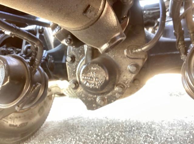 Peterbilt truck underside showing differential/drive housing with cast stamping and bolts.