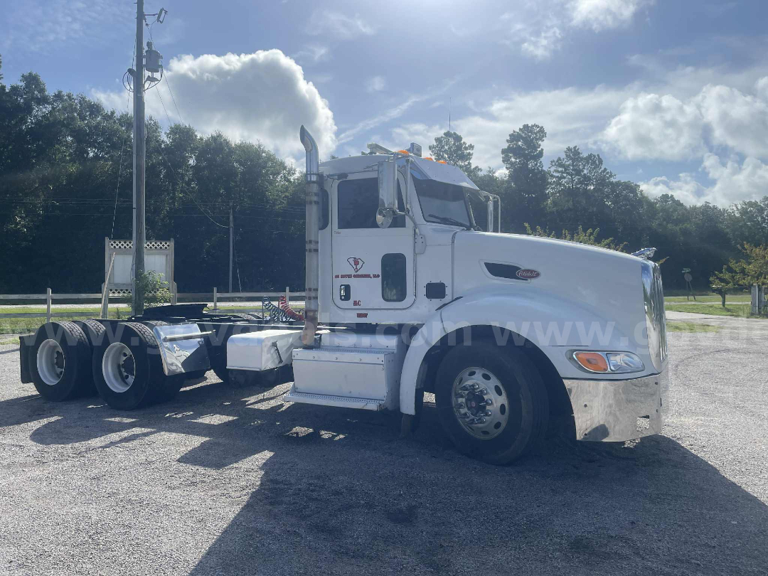 Peterbilt 386 truck cab and chassis in white, side view showing front grille, sleeper cabin, dual rear axles, chrome exhaust stack, steps, and fuel tanks.