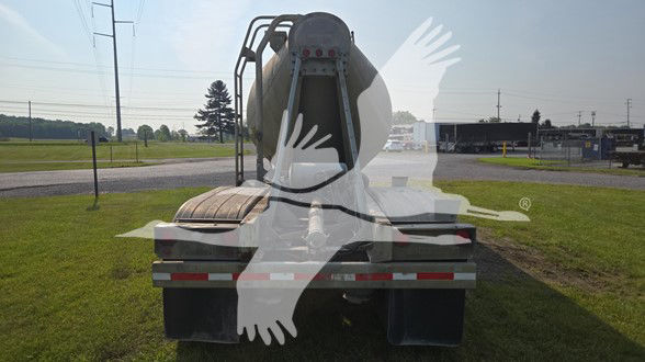 Fruehauf cement tank trailer rear view with open top hatch, metal frame, and rear bumper/reflectors.