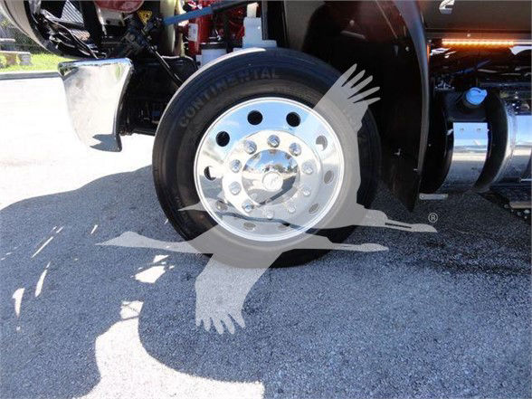 Continental tire and polished steel wheel on a truck front axle with surrounding components visible.
