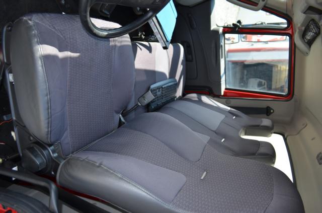 Interior cab of a 2013 International TerraStar showing driver seat and three passenger seats, with a keyboard on the center console.