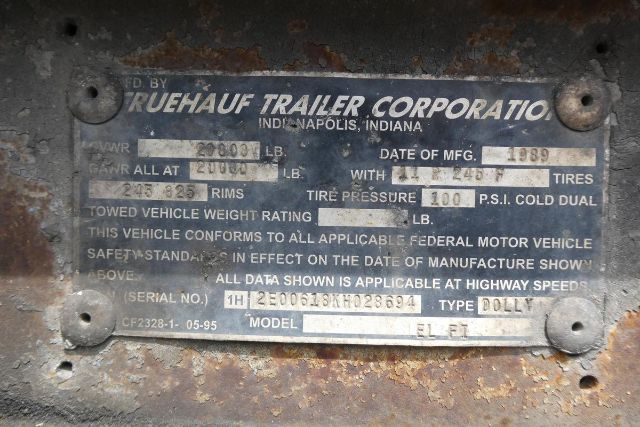 Dolly trailer identification plate showing FRUEHAUF TRAILER CORPORATION Indianapolis, Indiana with VIN 1H2E00618KH028694 and serial/model details for a 1989 Dolly trailer.