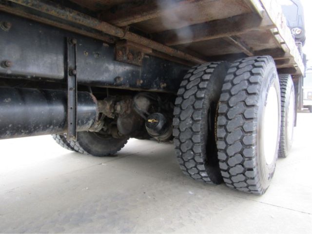 Underneath view of a 2003 Peterbilt 330 truck showing dual rear axles with heavy-duty tires and undercarriage components.