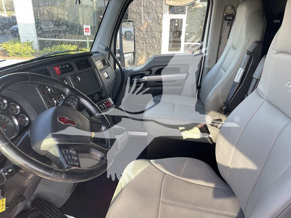 Kenworth T880 truck interior showing driver's seat, steering wheel, and front passenger seat.