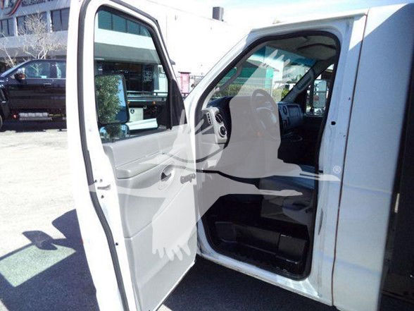Ford E-450 cargo van/flatbed interior with open front door showing gray/black dashboard and seating.