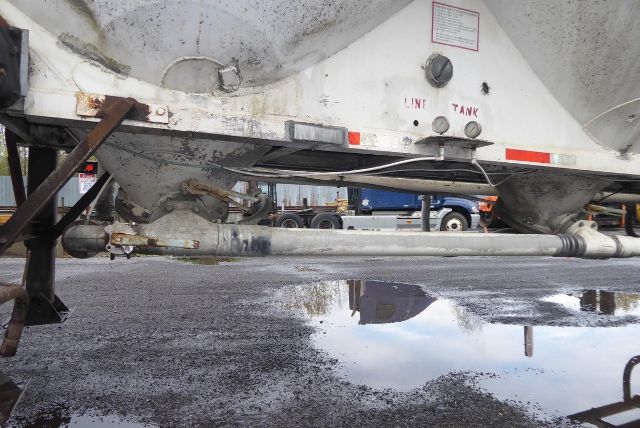 Fruehauf dry bulk trailer underside showing line tank access and hydraulic piping.