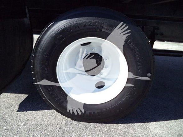 Wheel and tire on a box truck showing white steel rim with black tire; watermark overlay partially obscures, no legible model text.